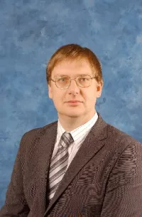 A headshot of Andrew Booth